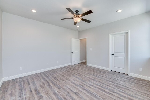 unfurnished room featuring ceiling fan and light wood-type flooring