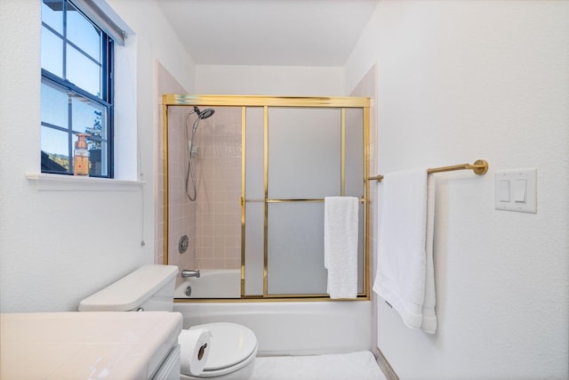 full bathroom with toilet, vanity, and bath / shower combo with glass door