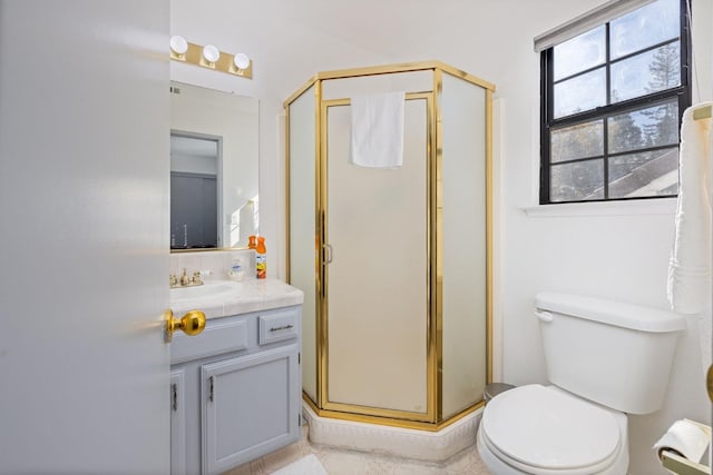 bathroom featuring vanity, toilet, and an enclosed shower