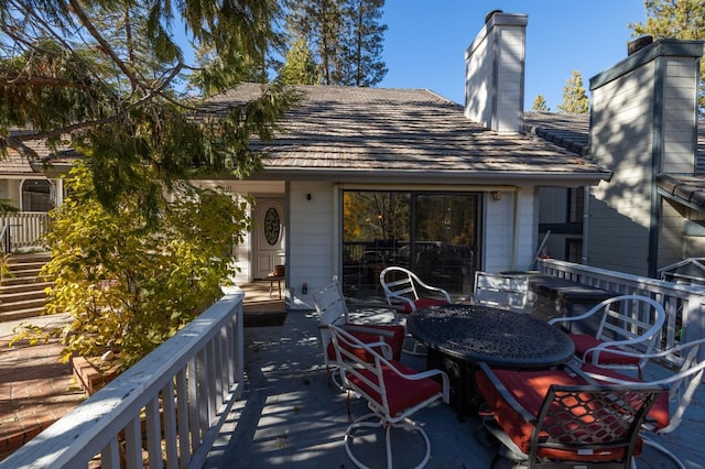 back of house featuring a wooden deck