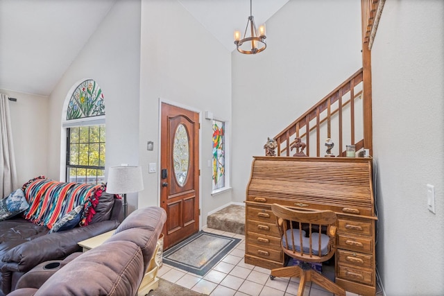 foyer with an inviting chandelier, high vaulted ceiling, and light tile patterned floors