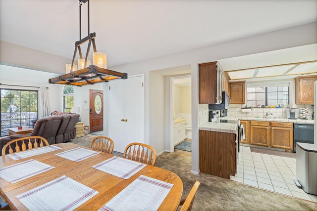 carpeted dining space with sink