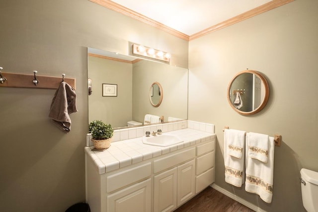 bathroom featuring hardwood / wood-style floors, vanity, toilet, and crown molding