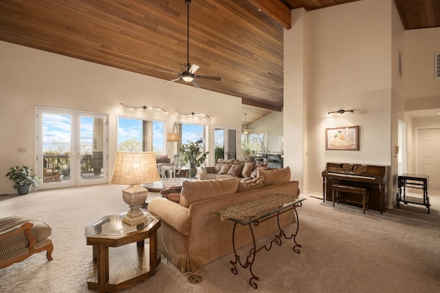 carpeted living room with high vaulted ceiling, ceiling fan, a healthy amount of sunlight, and wood ceiling