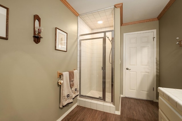 bathroom with hardwood / wood-style floors, walk in shower, and crown molding