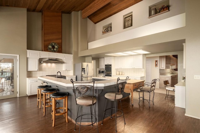 kitchen featuring appliances with stainless steel finishes, tasteful backsplash, and white cabinetry