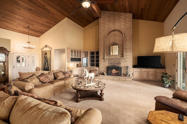 carpeted living room featuring a fireplace, high vaulted ceiling, wood ceiling, and ceiling fan with notable chandelier