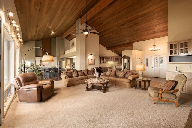 living room featuring beam ceiling, high vaulted ceiling, wood ceiling, and ceiling fan with notable chandelier