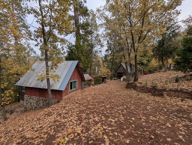 view of property exterior with an outdoor structure