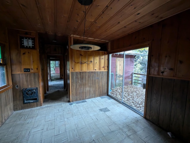 doorway featuring wood ceiling, wooden walls, and heating unit