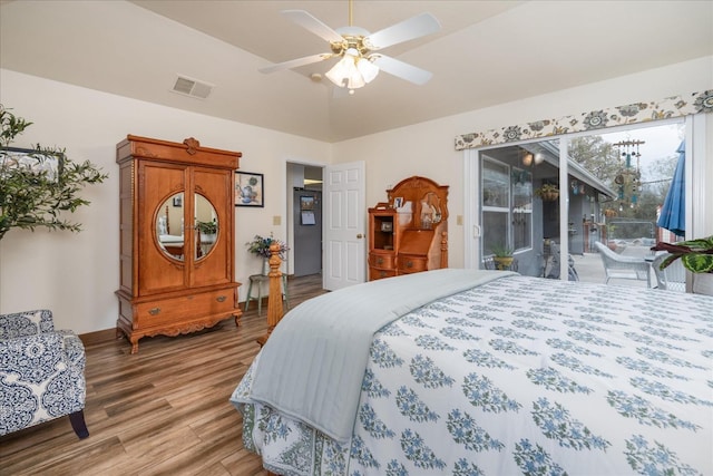 bedroom featuring hardwood / wood-style floors, ceiling fan, and access to outside