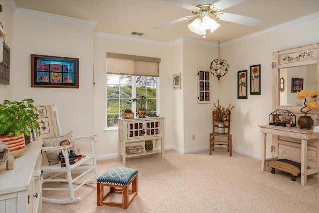 sitting room featuring light colored carpet, ceiling fan, and ornamental molding