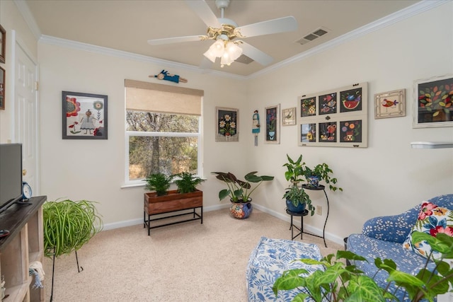 sitting room featuring carpet flooring, ceiling fan, and ornamental molding