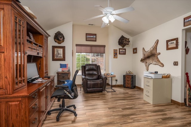 office featuring ceiling fan, hardwood / wood-style floors, and vaulted ceiling