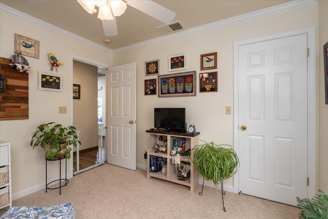 interior space with crown molding, ceiling fan, and light carpet