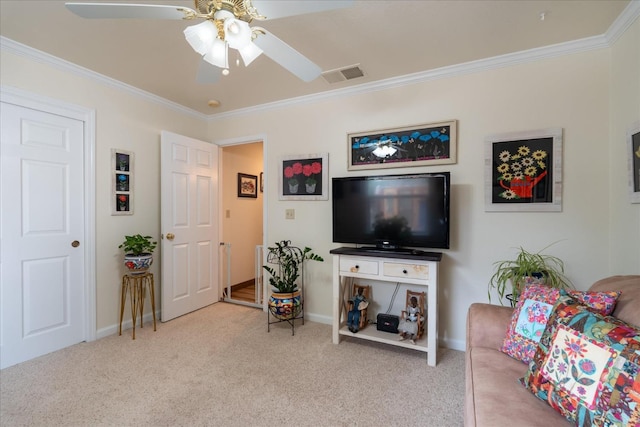 carpeted living room with ceiling fan and ornamental molding