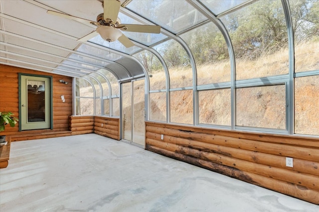 unfurnished sunroom featuring ceiling fan