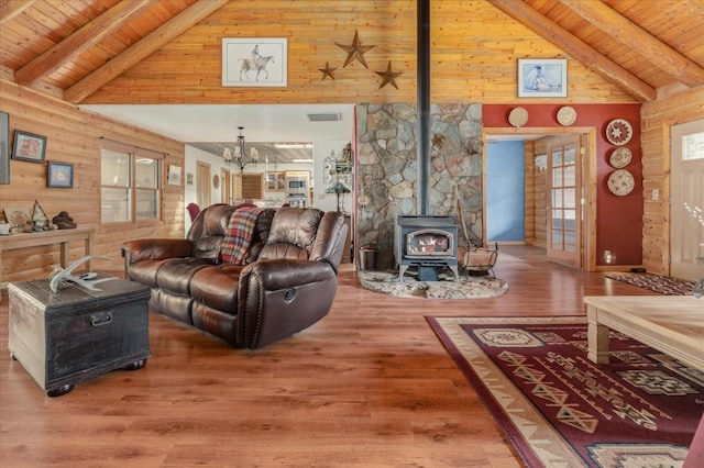 living room with a wood stove, hardwood / wood-style floors, and wooden ceiling