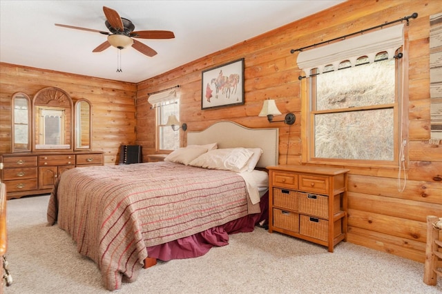 bedroom with ceiling fan, log walls, and light carpet