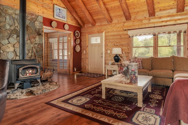 living room featuring wood-type flooring, beam ceiling, high vaulted ceiling, wooden ceiling, and a wood stove