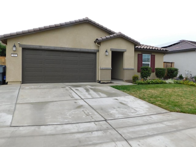 view of front facade with a garage and a front lawn