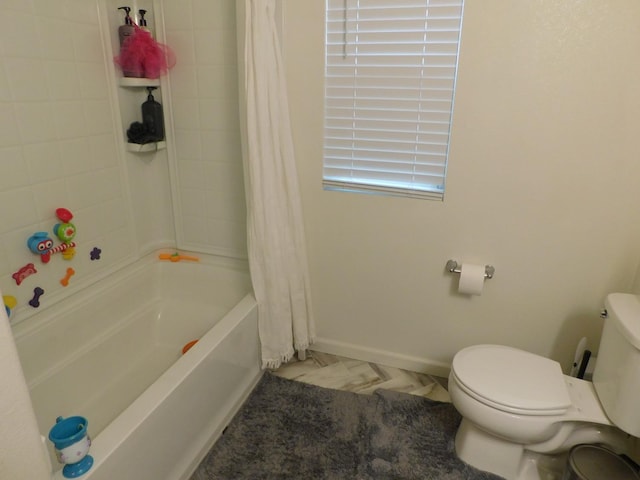 bathroom featuring toilet and shower / tub combo with curtain