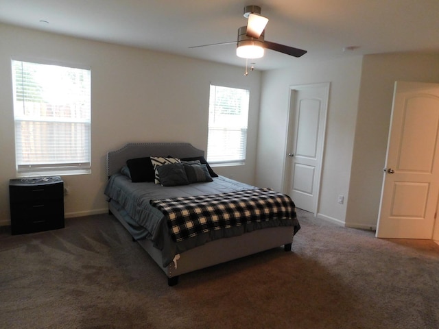 carpeted bedroom featuring multiple windows and ceiling fan