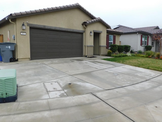 view of front of home featuring a garage and a front lawn