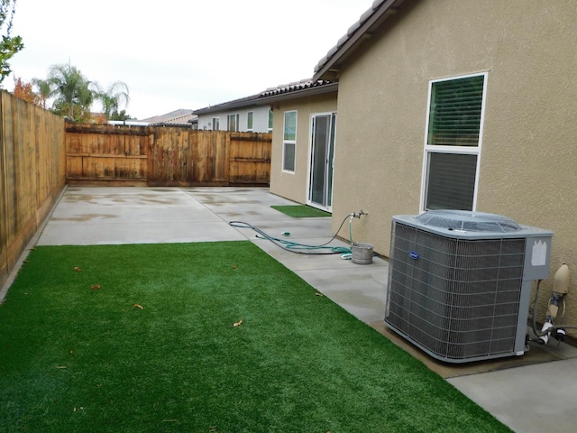 view of yard featuring a patio and central AC unit