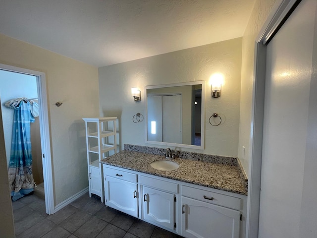 bathroom with tile patterned floors and vanity