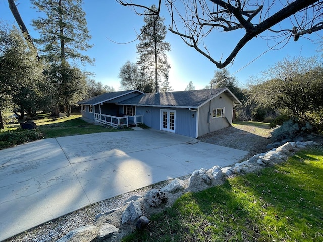 view of front facade featuring french doors and a front yard