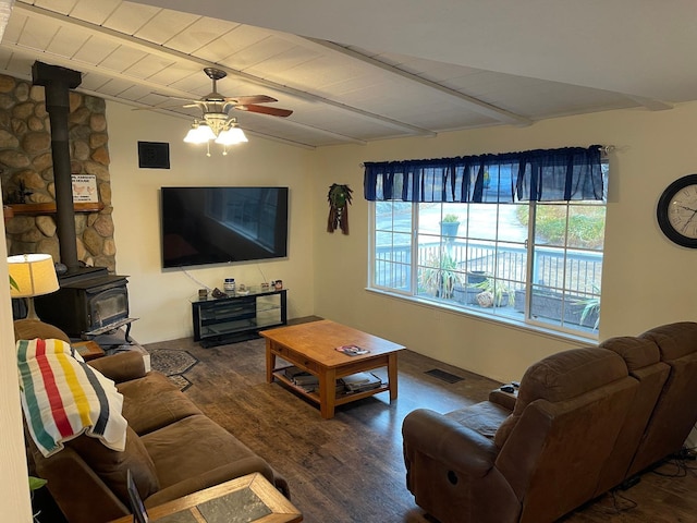 living room with dark hardwood / wood-style floors, wood ceiling, a wood stove, ceiling fan, and vaulted ceiling with beams