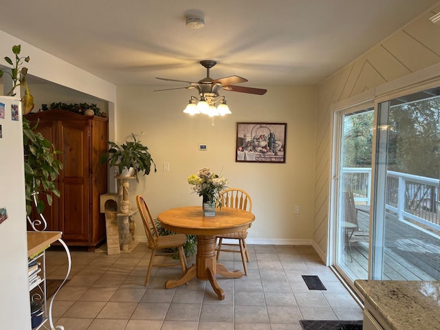 tiled dining space featuring ceiling fan