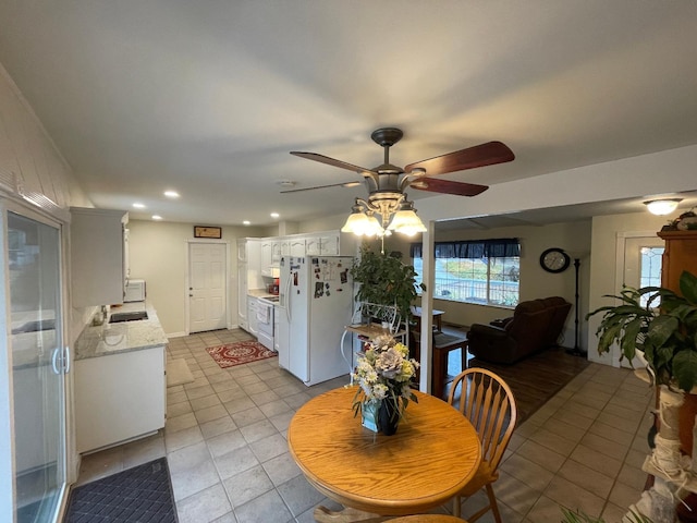 dining room featuring ceiling fan and sink