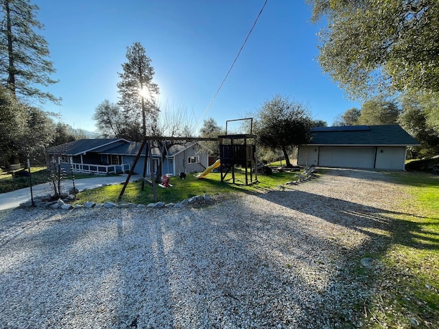 view of front of property with a front lawn and a playground