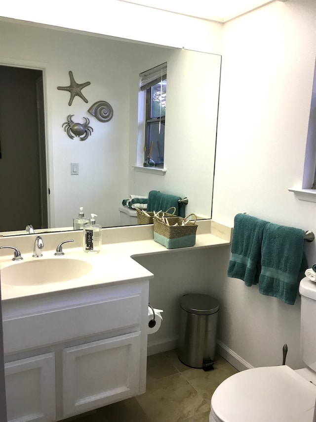 bathroom featuring tile patterned flooring, vanity, and toilet