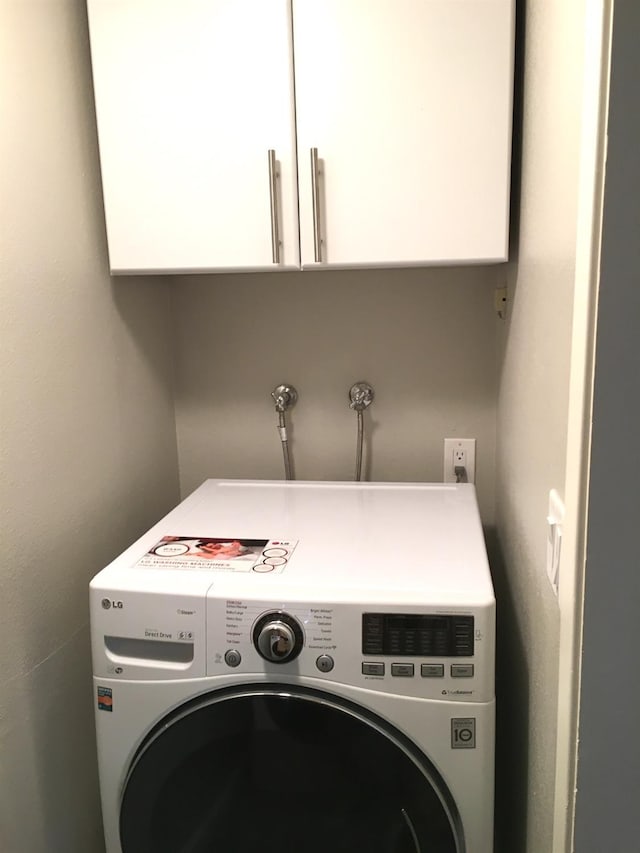 washroom featuring cabinets and washer / dryer