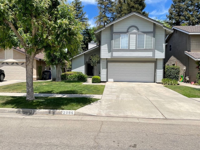 view of front of property with a garage and a front lawn