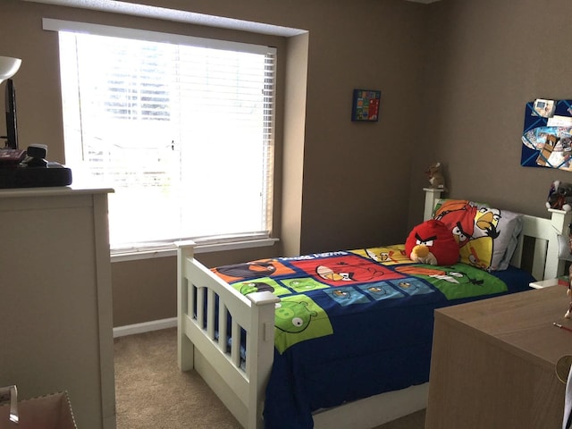 bedroom featuring light colored carpet