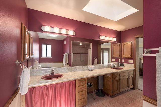 bathroom with tile patterned flooring, a shower, and vanity