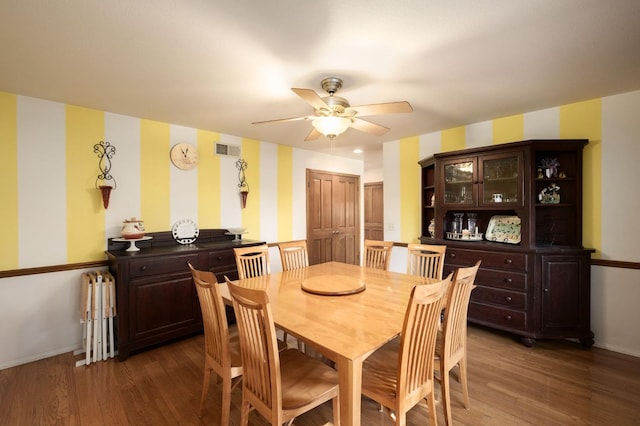 dining room with radiator, ceiling fan, and dark hardwood / wood-style floors