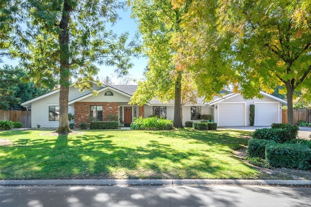 ranch-style home with a garage and a front lawn