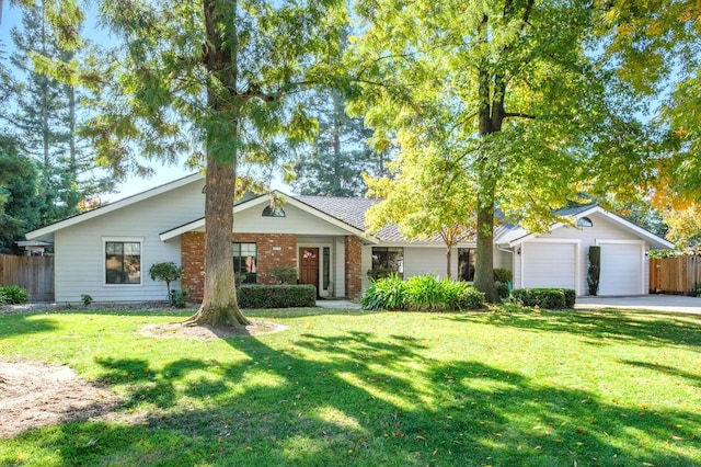 single story home featuring a garage and a front lawn