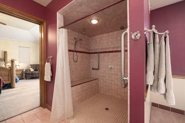 bathroom with a shower with shower curtain and tile patterned floors