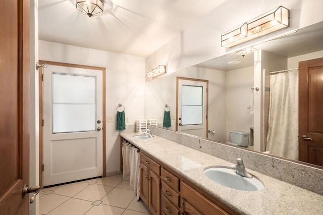 bathroom featuring tile patterned flooring, vanity, and toilet