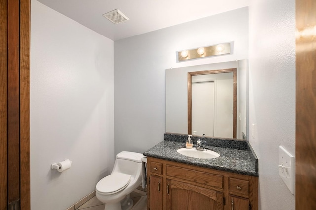 bathroom featuring tile patterned flooring, vanity, and toilet