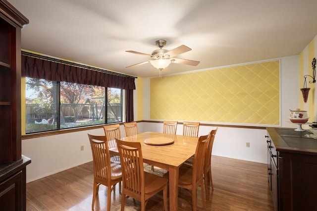 dining space featuring hardwood / wood-style flooring and ceiling fan