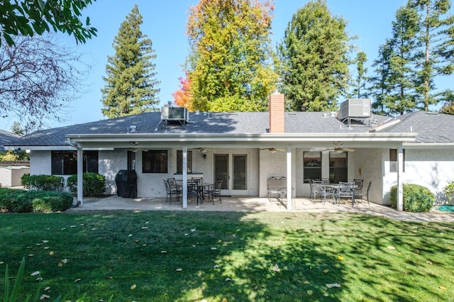 back of property featuring a lawn, a patio area, and ceiling fan