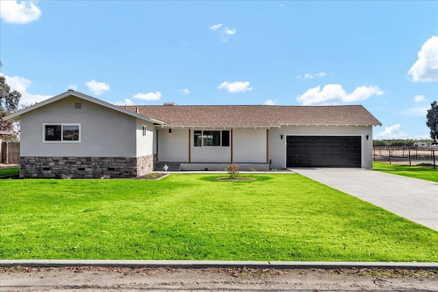 ranch-style house featuring covered porch, a garage, and a front lawn