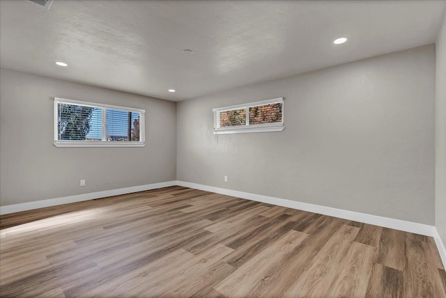 spare room featuring light hardwood / wood-style floors